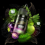 A 30ml bottle of Flavour Beast x Twelve Monkeys vape juice surrounded by green apples, purple grapes, ice cubes and green leaves. Available at Underground Vapes Woodstock and London.