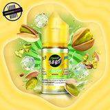 A 30ml bottle of Flavour Beast Cravin' Series E-Liquid in pistachio dream iced flavour. The bottle is surrounded by pistachios and ice cubes. Underground Vapes Woodstock and London