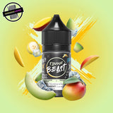 A 30ml bottle of Flavour Beast E-liquid in honeydew mango ice flavour, surrounded by mangoes and honeydew slices and ice cubes, on a bright yellow-green background. Underground Vapes Woodstock and London