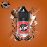 A 30ml bottle of Flavour Beast E-liquid in iced mocha flavour, surrounded by coffee and cocoa beans, and ice cubes, on a brown background. Underground Vapes Woodstock and London