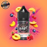 A 30ml bottle of Flavour Beast E-liquid in peach berry flavour, surrounded by raspberries, blueberries, and peach slices, on a bright peachy pink background. Underground Vapes Woodstock and London
