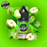 A 30ml bottle of Flavour Beast E-liquid in sour apple ice flavour, surrounded by green apple slices and ice cubes, on a bright green background. Underground Vapes Woodstock and London