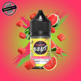 A 30ml bottle of Flavour Beast E-liquid in sweet watermelon flavour, surrounded by watermelon slices, on a bright pink and green background. Underground Vapes Woodstock and London