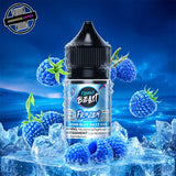 A 30ml bottle of Flavour Beast E-liquid Frozen Series in blue razz iced flavour, sitting on a pile of ice and surrounded by blue raspberries, on a bright blue background. Underground Vapes Woodstock and London