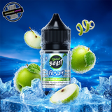 A 30ml bottle of Flavour Beast E-liquid Frozen Series in green apple iced flavour, sitting on a pile of ice and surrounded by green apple slices, on a bright blue background. Underground Vapes Woodstock and London
