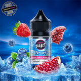 A 30ml bottle of Flavour Beast E-liquid Frozen Series in triple berry iced flavour, sitting on a pile of ice and surrounded by blueberries, strawberries, and pomegranate on a bright blue background. Underground Vapes Woodstock and London