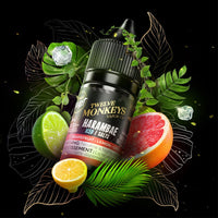 A 30ml bottle of Flavour Beast x Twelve Monkeys vape juice surrounded by grapefruit, lemon, lime, ice cubes and green leaves. Available at Underground Vapes Woodstock and London.