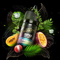 A 30ml bottle of Flavour Beast x Twelve Monkeys vape juice surrounded by lychee, passionfruit, papaya, ice cubes and green leaves. Available at Underground Vapes Woodstock and London.