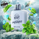 A white prefilled 20ml vape pod by Flavour Beast in peppermint ice flavour surrounded by mint leaves and ice. Underground Vapes Woodstock and London